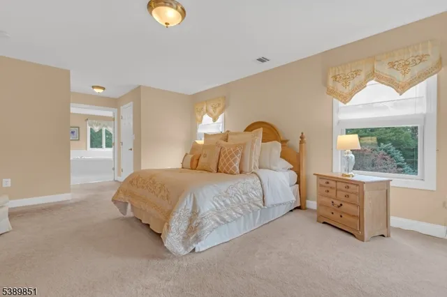 a spacious bedroom with a bed and a cabinets