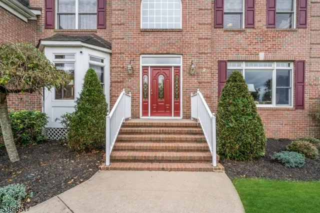 a view of a house with large windows and a yard