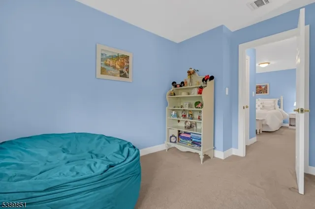 a bedroom with a bed and a book shelf