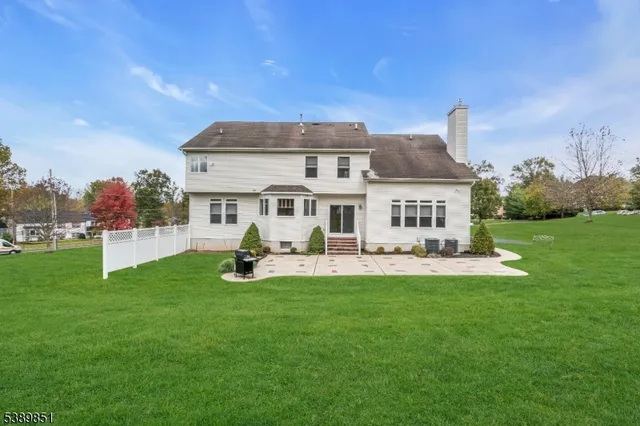 a view of a house with a yard and sitting area
