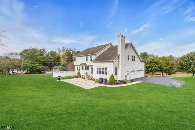 a view of a house with a yard and sitting area