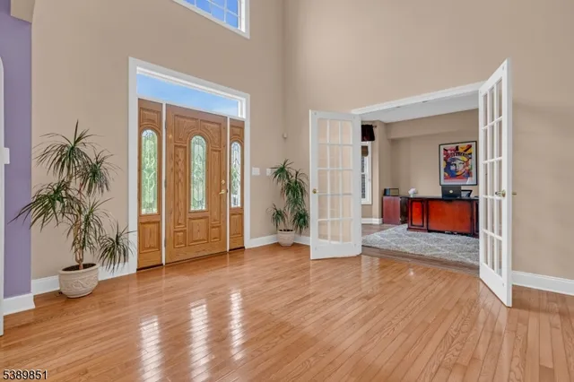 a view of a hallway with wooden floor and a potted plant