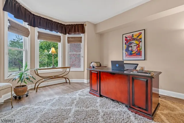 a living room with furniture a window and a flat screen tv