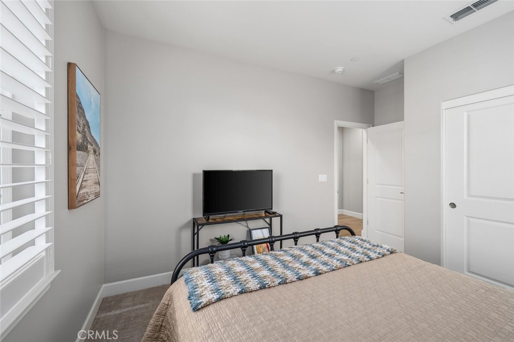 1658 Eucalyptus Road Nipomo, CA 93444 - Photo 35 of 75 a bedroom with a bed and a flat screen tv