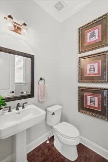 a bathroom with a granite countertop sink a toilet and a mirror