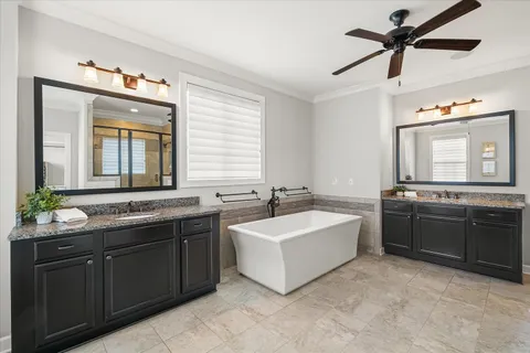 a bathroom with a granite countertop sink toilet mirror and shower