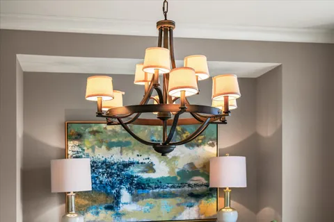 a living room with furniture chandelier and a rug