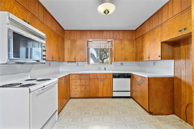 a view of a kitchen with a sink and cabinet