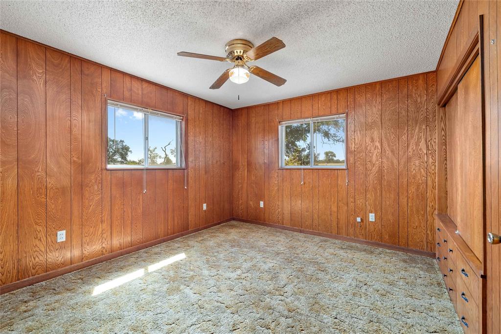 53 County Road 312 Goldthwaite, TX 76844 - Photo 26 of 35 an empty room with windows and fan