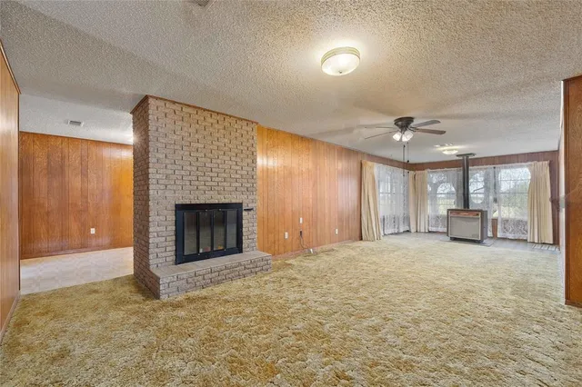 a view of an empty room and a fireplace