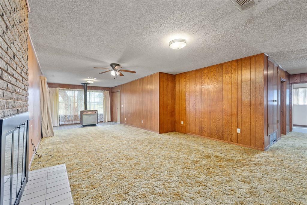 53 County Road 312 Goldthwaite, TX 76844 - Photo 7 of 35 a view of an empty room with window and wooden floor