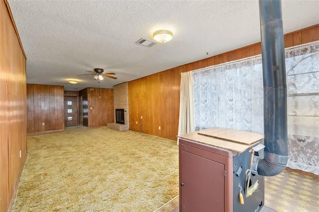 a view of livingroom with kitchen and windows