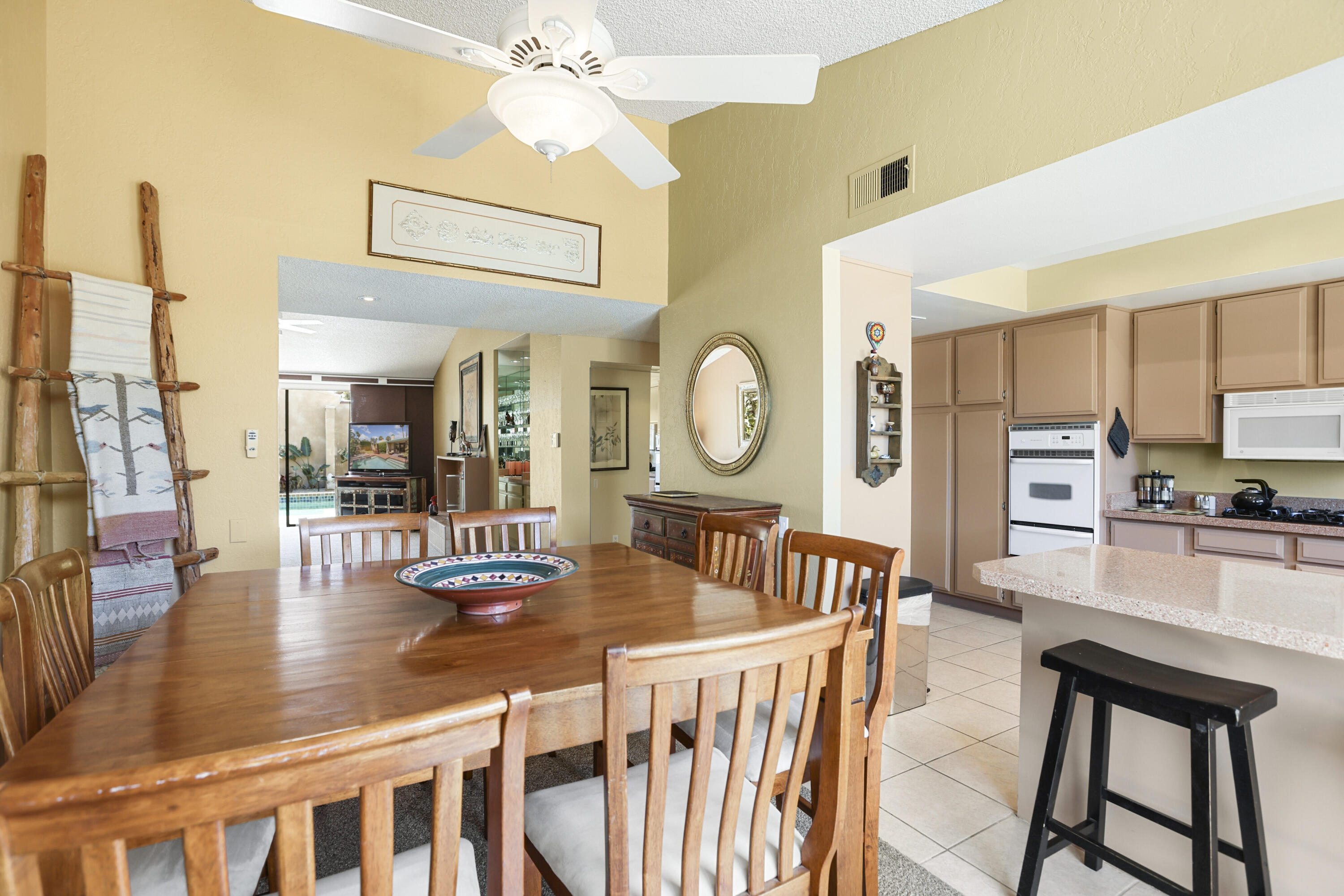 377 West Dominguez Road Palm Springs, CA 92262 - Photo 13 of 29 a dining room with furniture a mirror and a large window