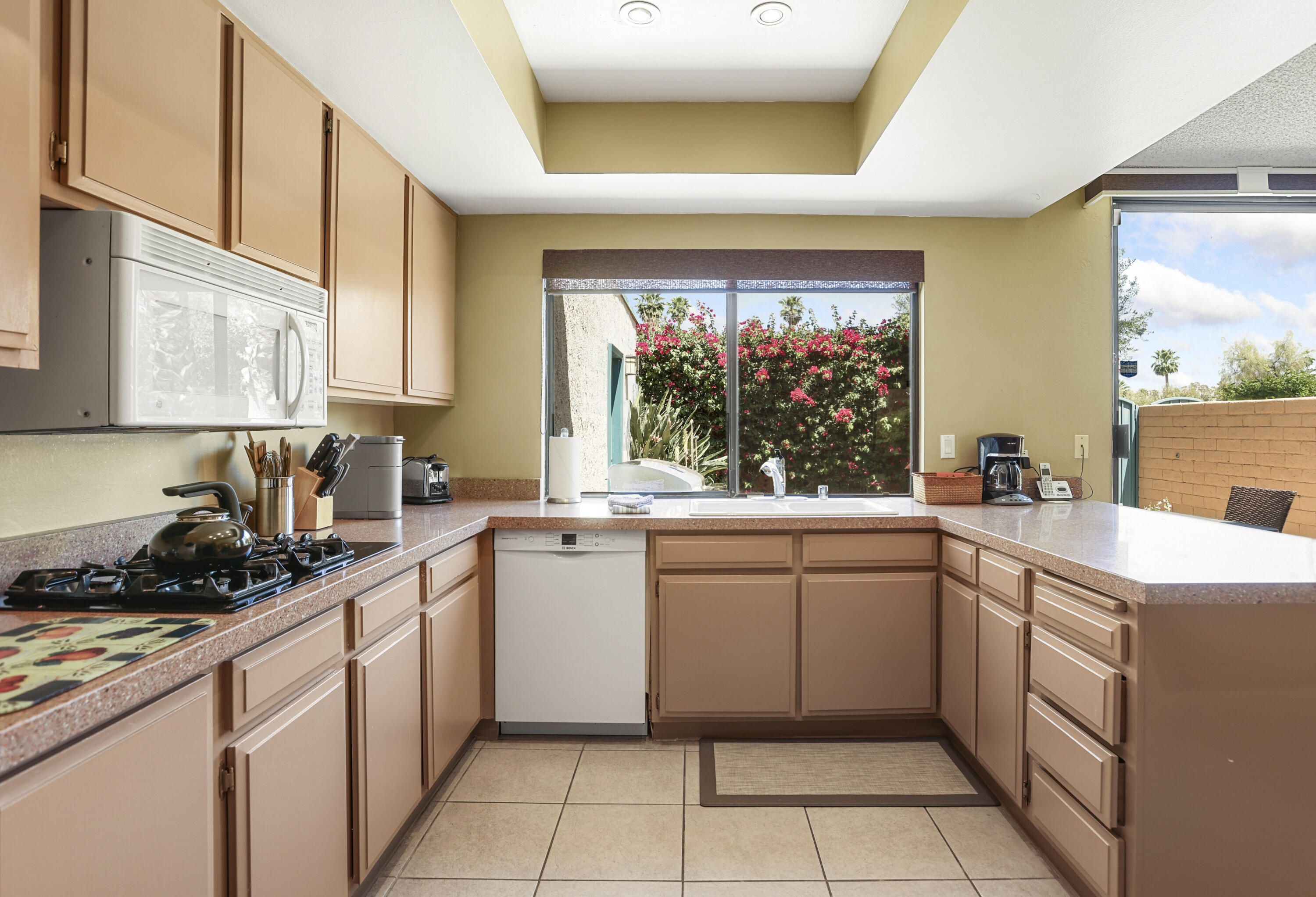377 West Dominguez Road Palm Springs, CA 92262 - Photo 15 of 29 a kitchen with a sink window and cabinets