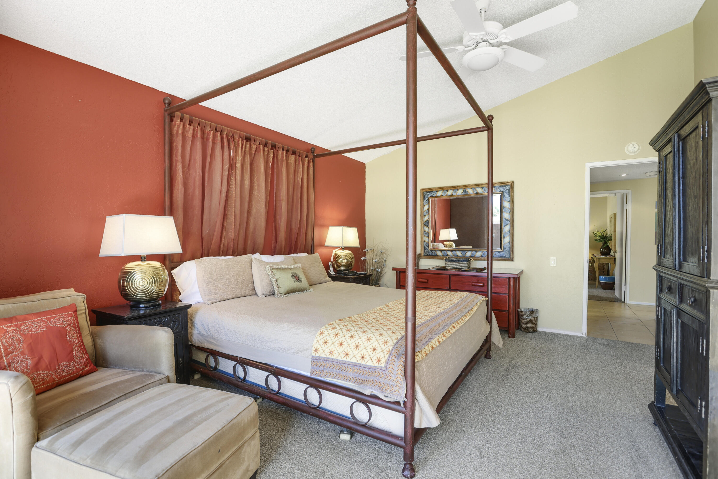 377 West Dominguez Road Palm Springs, CA 92262 - Photo 17 of 29 a bedroom with a bed a lamp and a flat screen tv