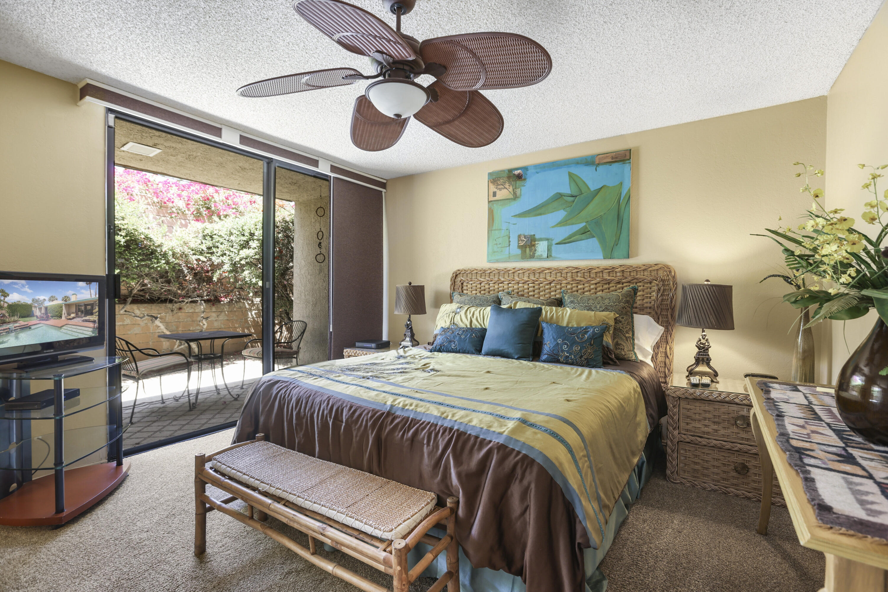 377 West Dominguez Road Palm Springs, CA 92262 - Photo 20 of 29 a bedroom with a large bed and a chandelier