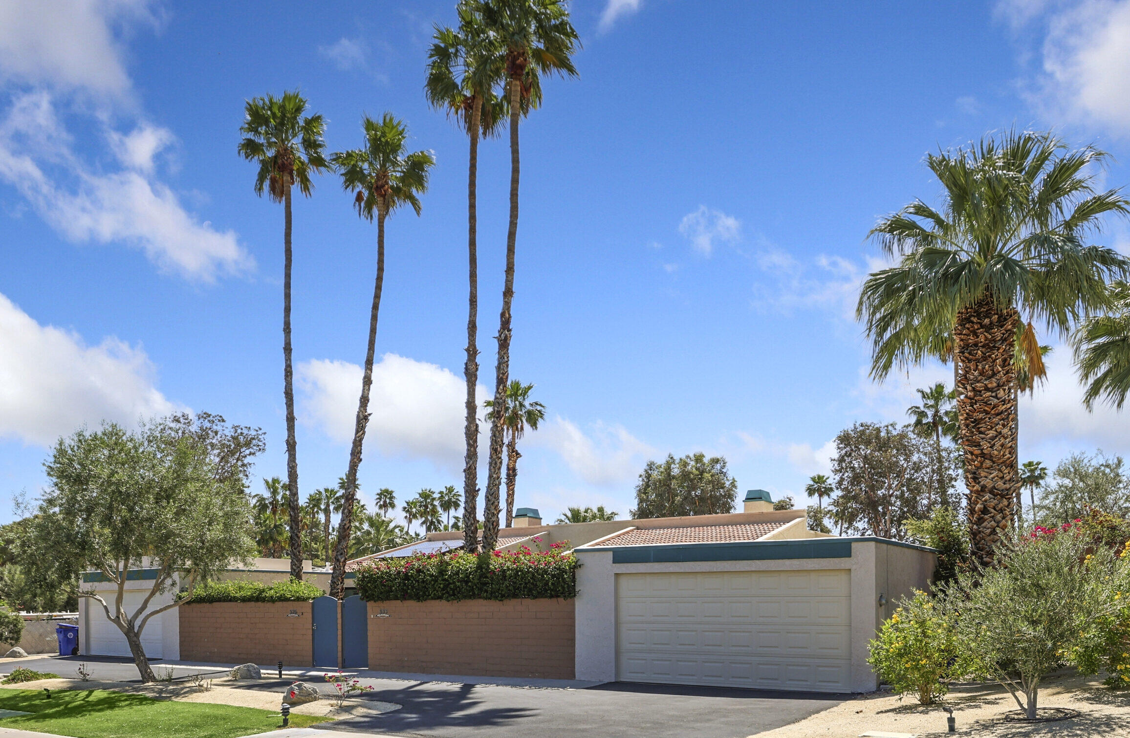 377 West Dominguez Road Palm Springs, CA 92262 - Photo 2 of 29 a view of a palm tree next to a tall building