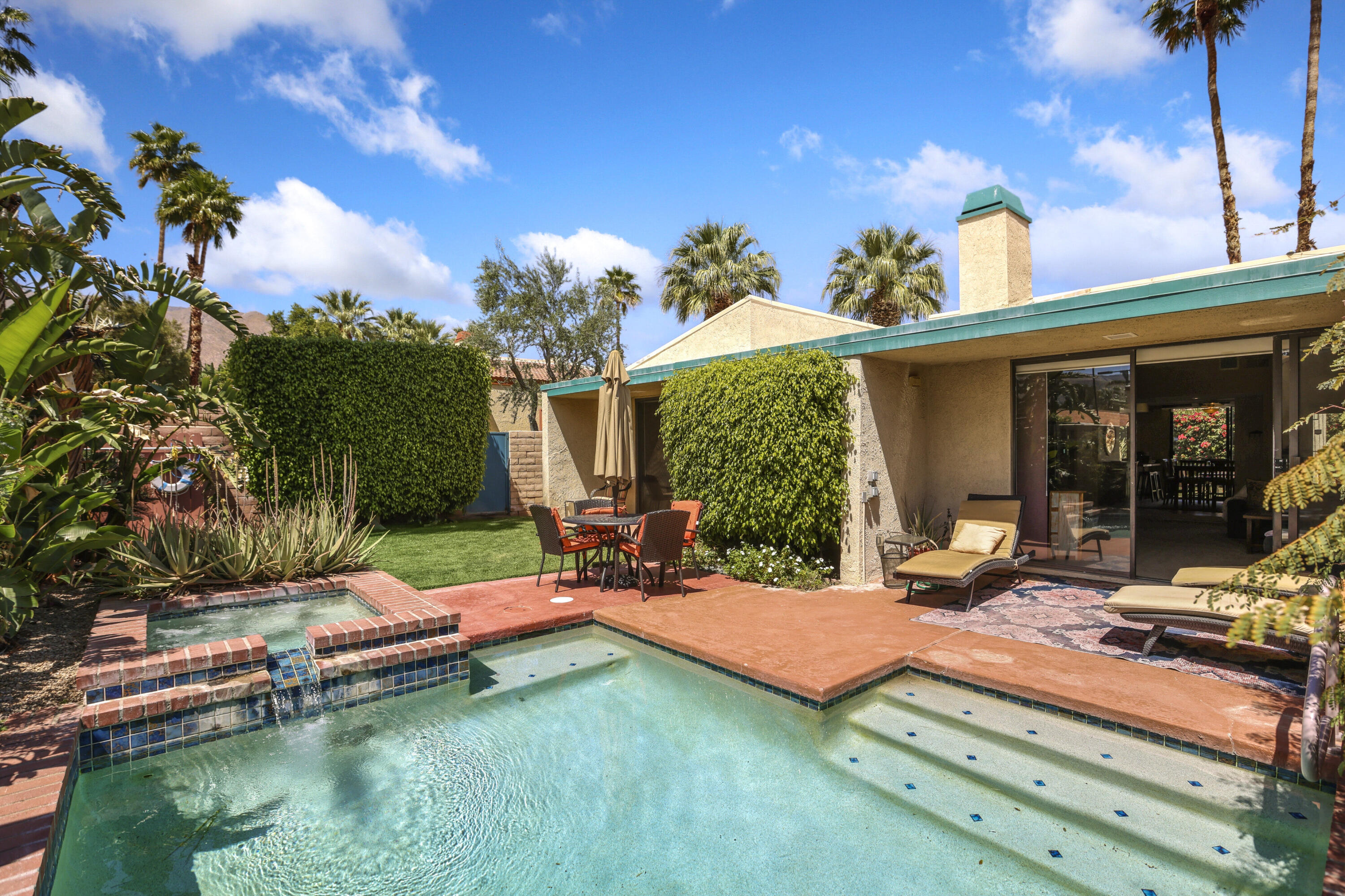 377 West Dominguez Road Palm Springs, CA 92262 - Photo 24 of 29 a view of a house with swimming pool and sitting area