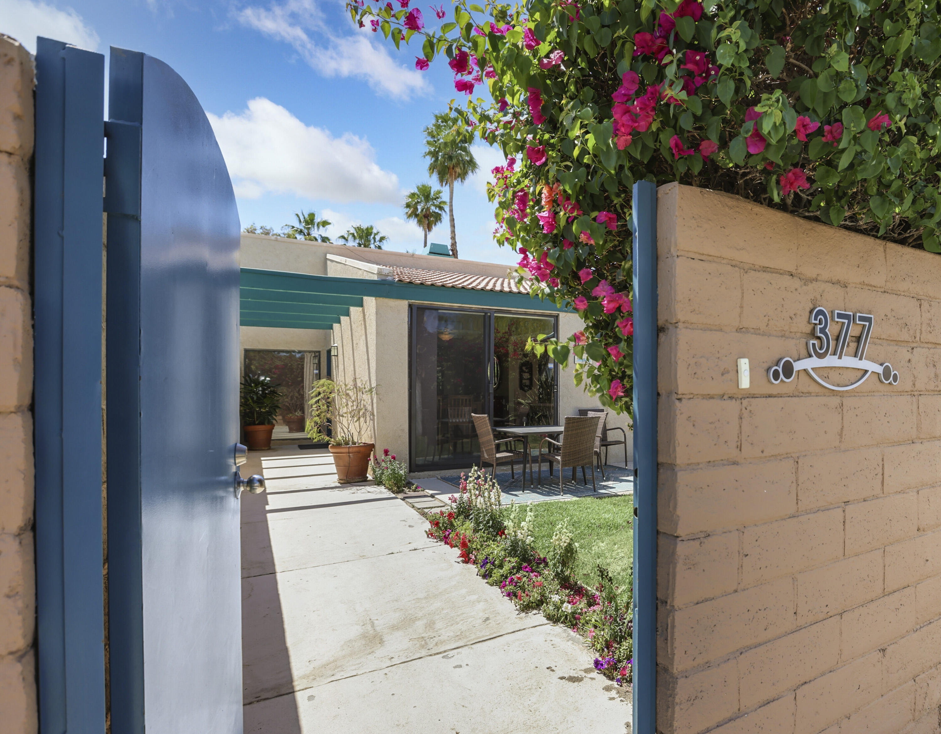 377 West Dominguez Road Palm Springs, CA 92262 - Photo 4 of 29 a backyard of a house with outdoor seating and flowers