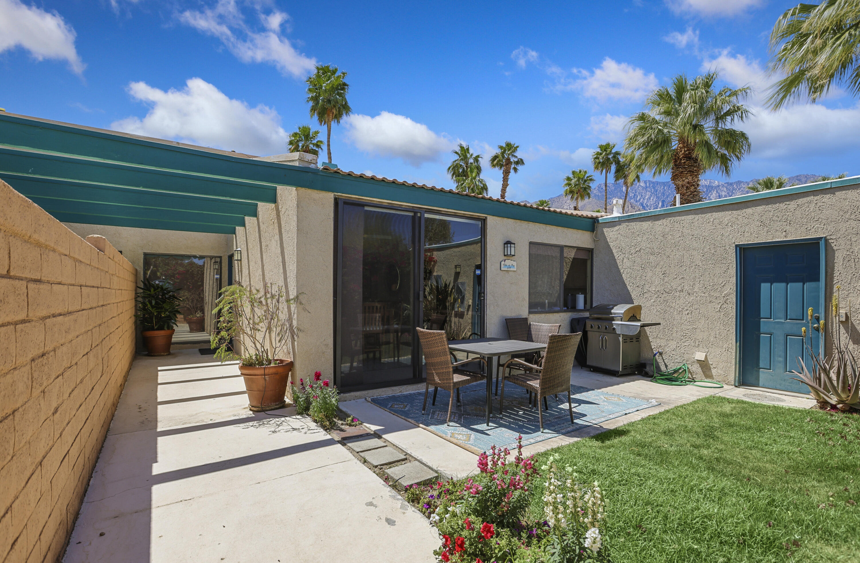 377 West Dominguez Road Palm Springs, CA 92262 - Photo 6 of 29 a view of a patio with table and chairs and potted plants