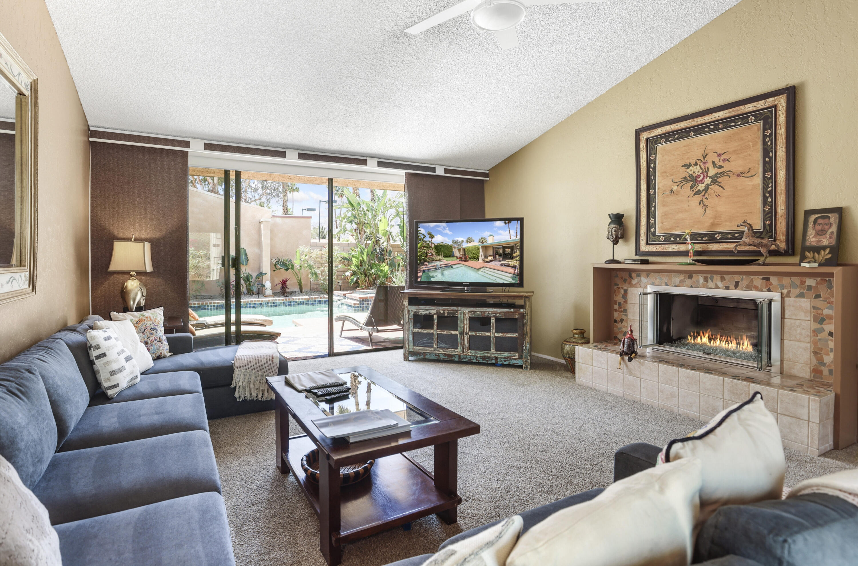 377 West Dominguez Road Palm Springs, CA 92262 - Photo 9 of 29 a living room with furniture a large window and a fireplace