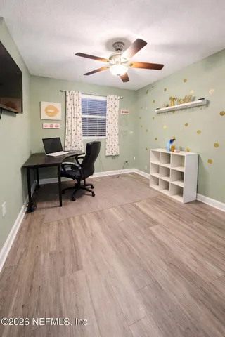 a view of a livingroom with furniture wooden floor and a window