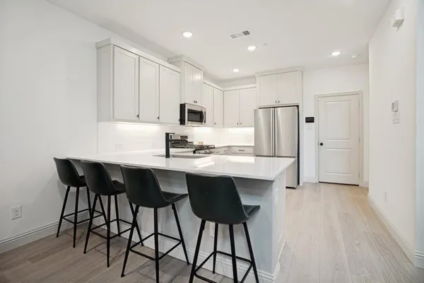 a spacious bathroom with a double vanity sink and a mirror