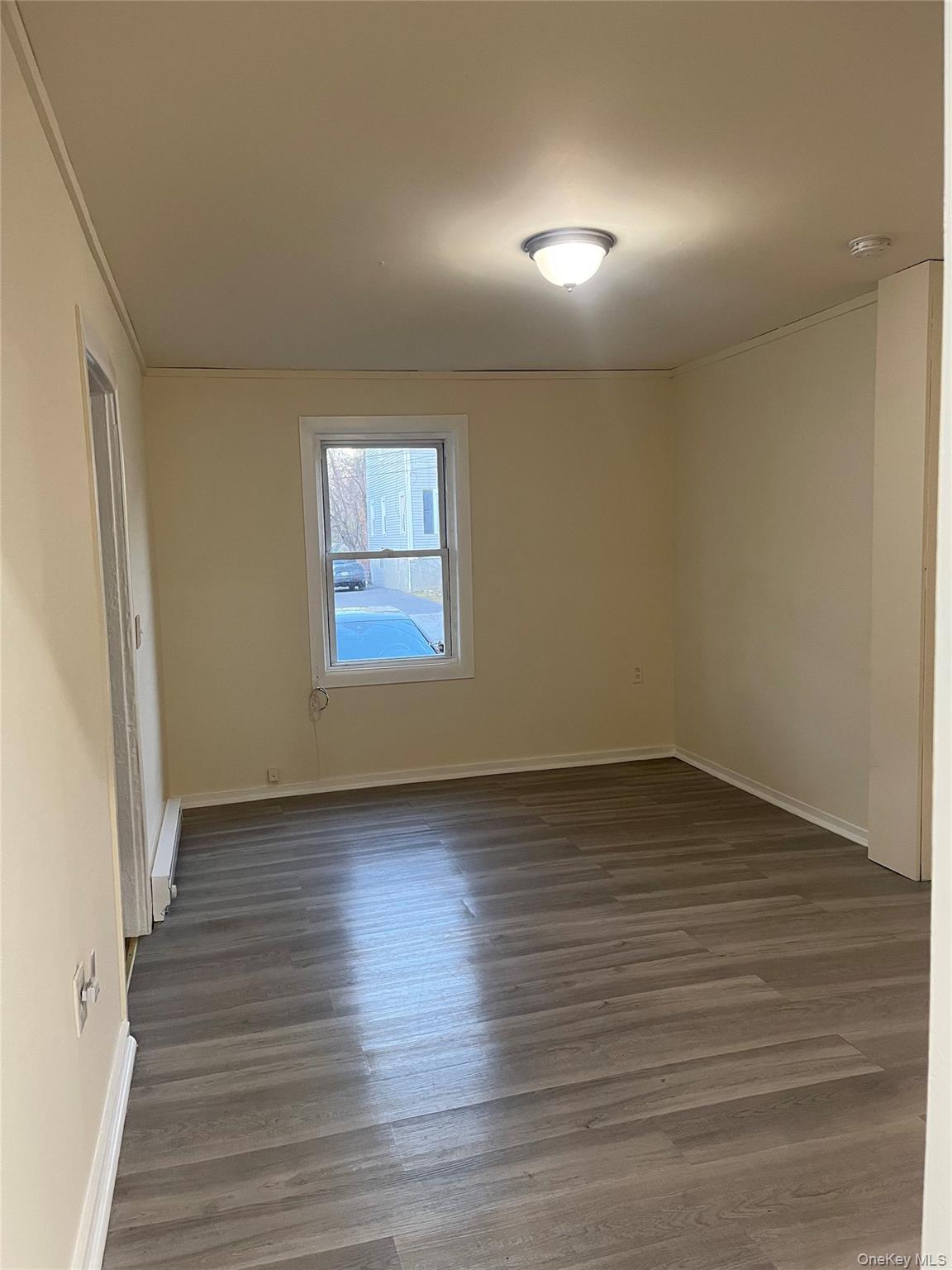 26 Franklindale Avenue, Unit 2 Wappingers Falls, NY 12590 - Photo 2 of 7 Empty room featuring dark wood-style floors and ornamental molding