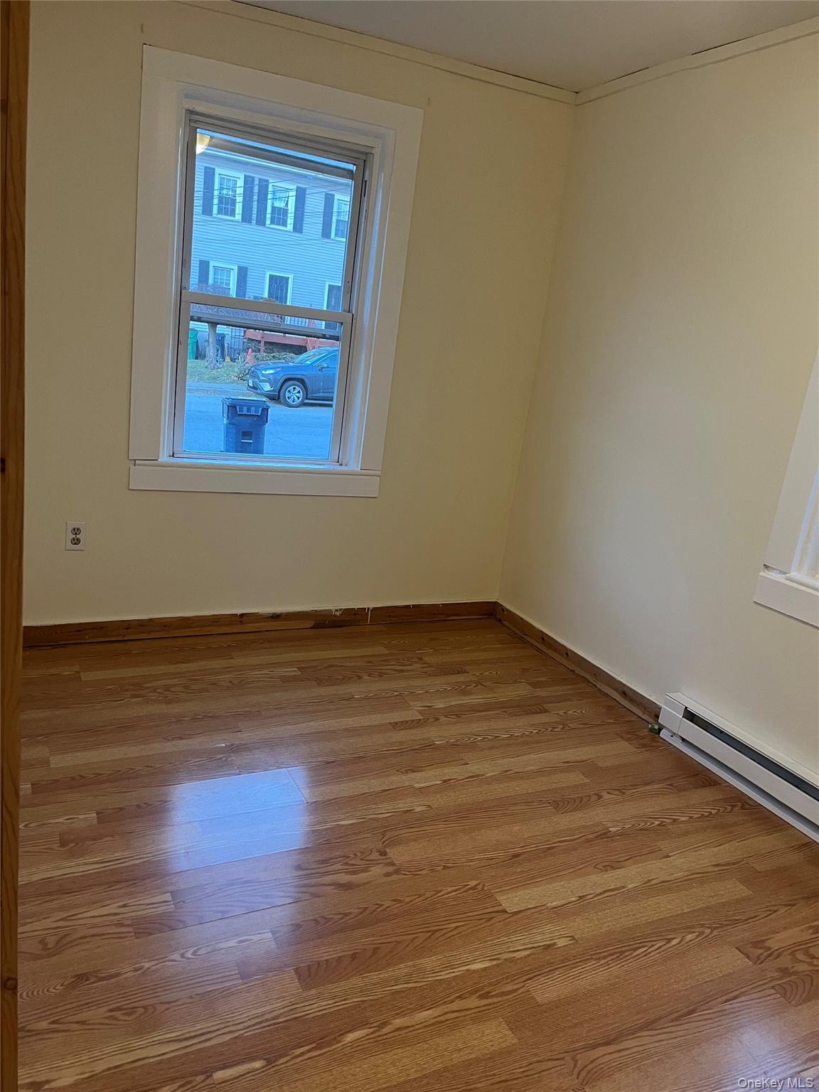 26 Franklindale Avenue, Unit 2 Wappingers Falls, NY 12590 - Photo 4 of 7 Unfurnished room featuring a baseboard heating unit and light wood-type flooring