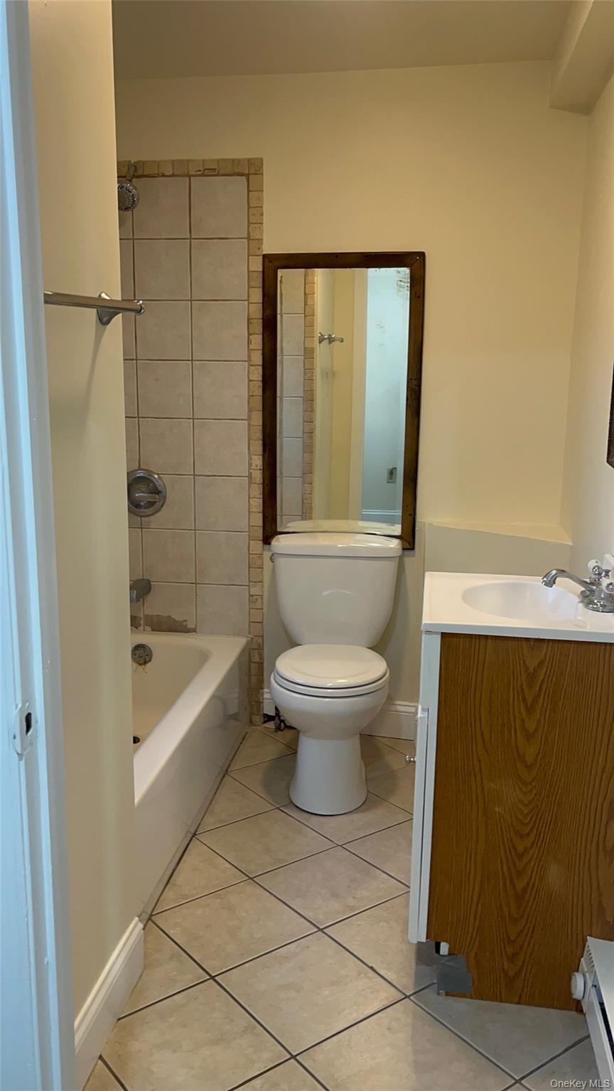 26 Franklindale Avenue, Unit 2 Wappingers Falls, NY 12590 - Photo 7 of 7 Bathroom with vanity, tub / shower combination, light tile patterned floors, and a baseboard heating unit