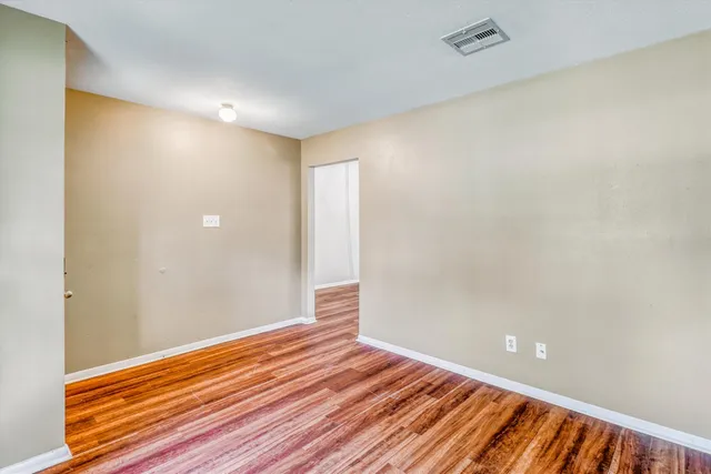 a view of room with wooden floor