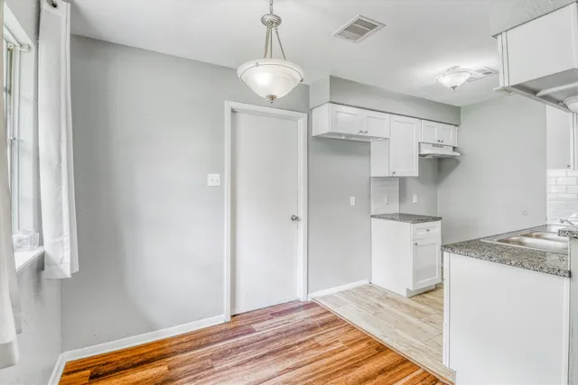 a kitchen that has a lot of cabinets