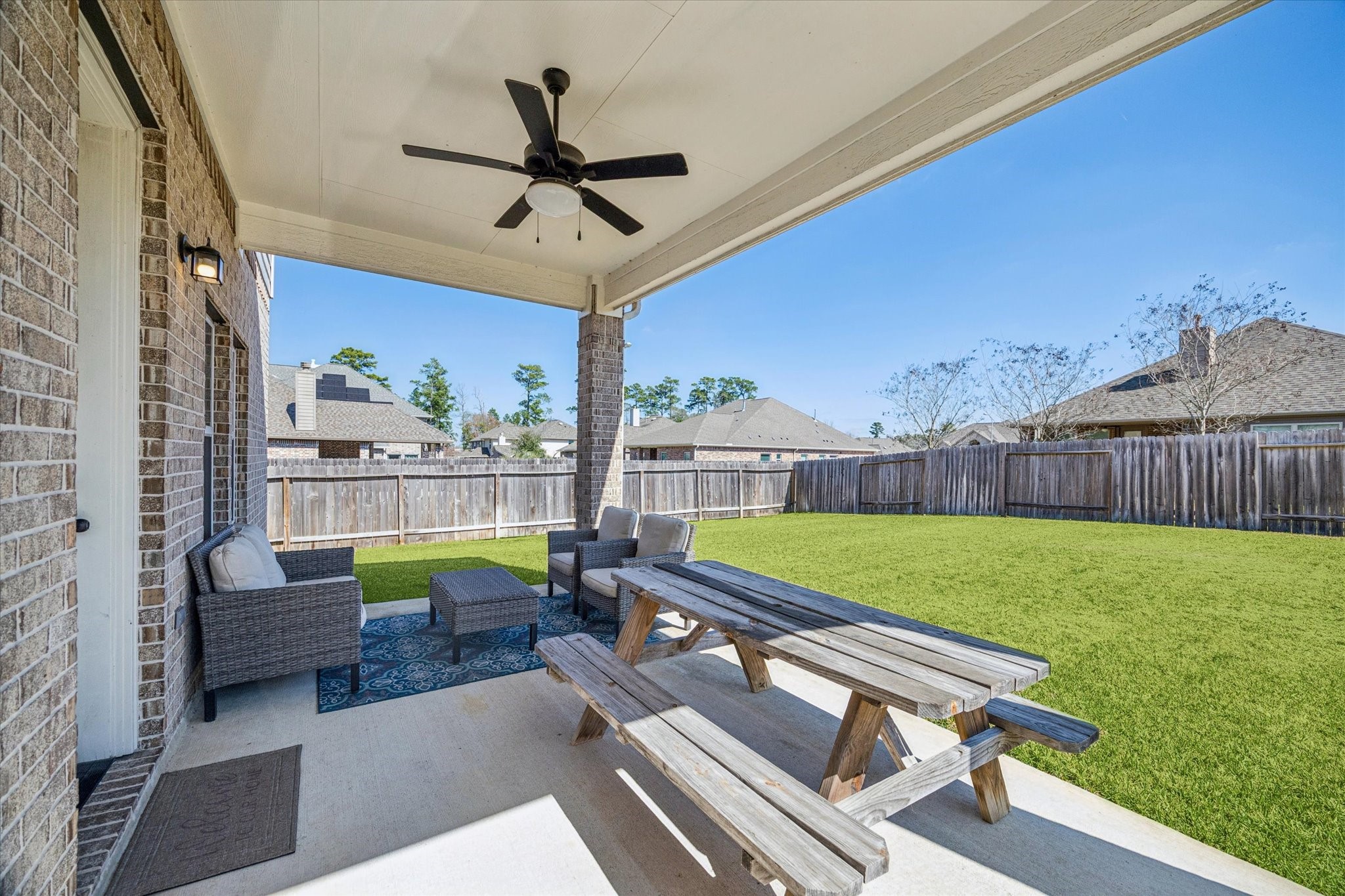 24030 Willow Rose Drive Spring, TX 77389 - Photo 33 of 39 Spacious backyard with a covered patio w/ceiling fan & plenty of room for outdoor seating.