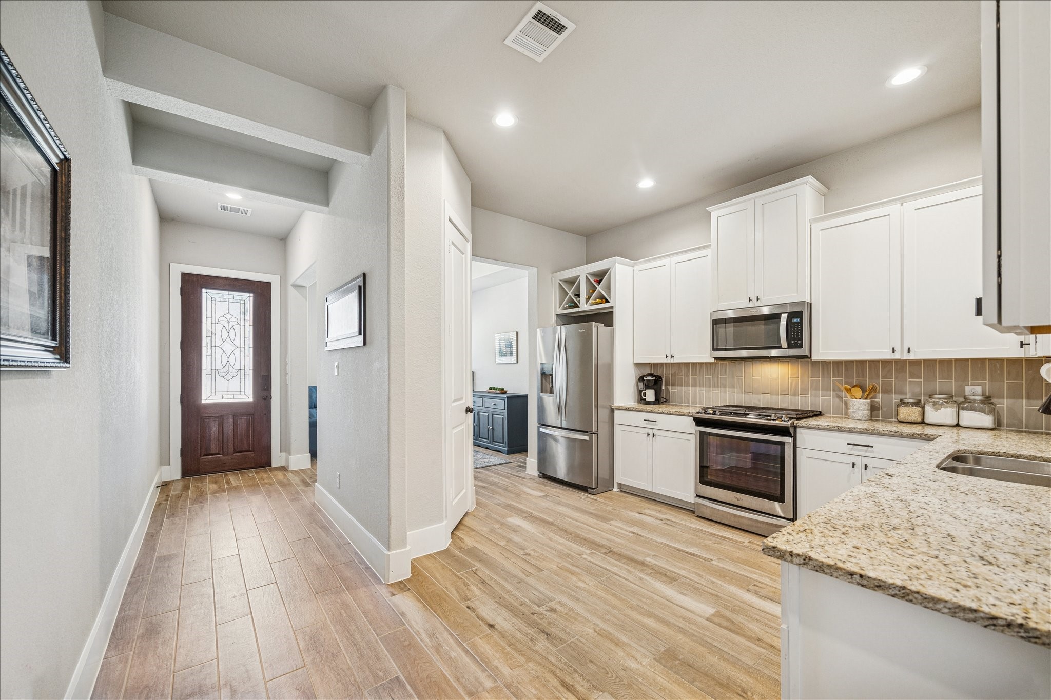 24030 Willow Rose Drive Spring, TX 77389 - Photo 6 of 39 a view of a kitchen with a sink stove and refrigerator