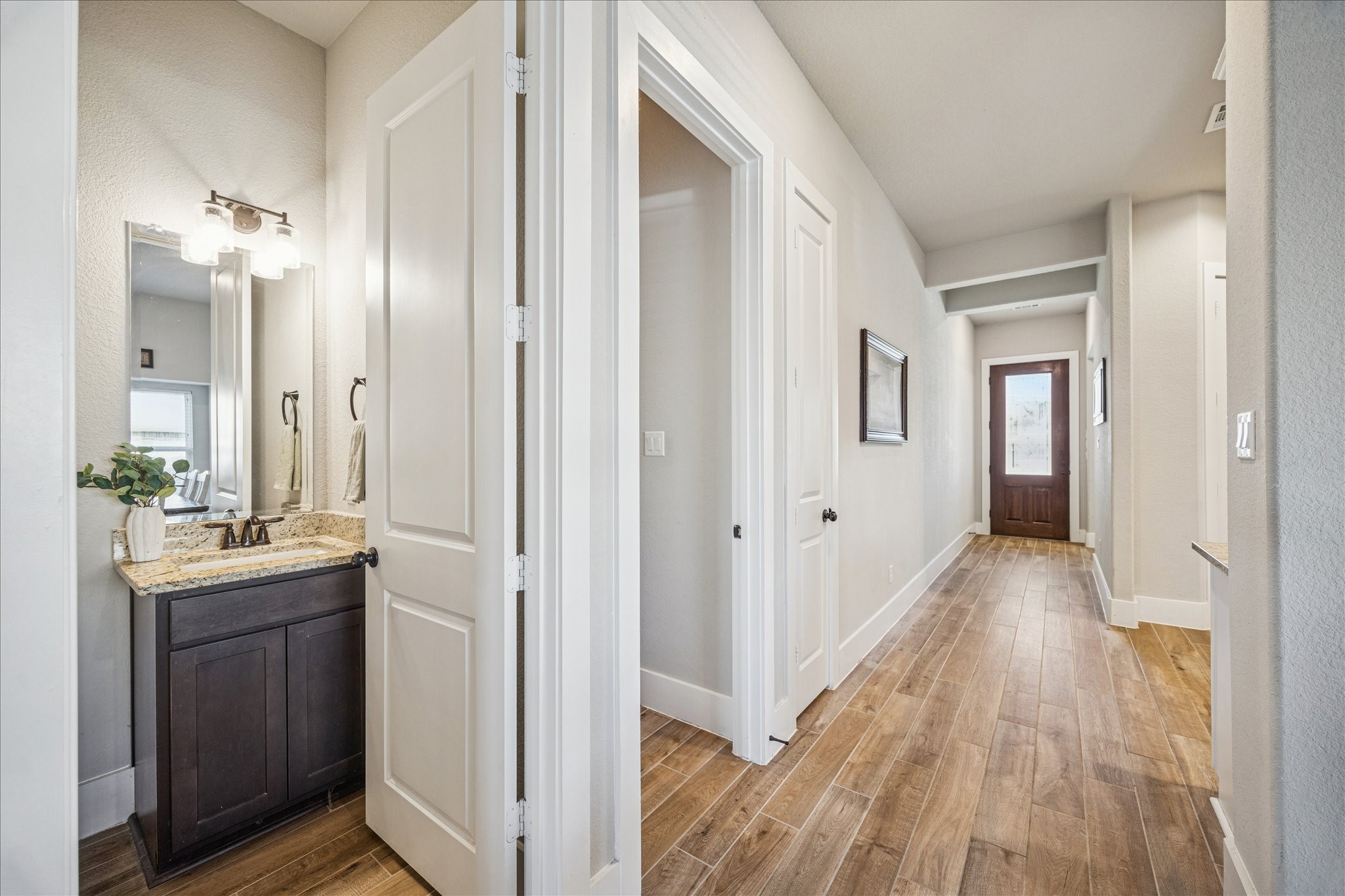24030 Willow Rose Drive Spring, TX 77389 - Photo 10 of 39 There is a small, elegant half bathroom along the hallway leading into the living room. To the right of the bathroom is the laundry room.