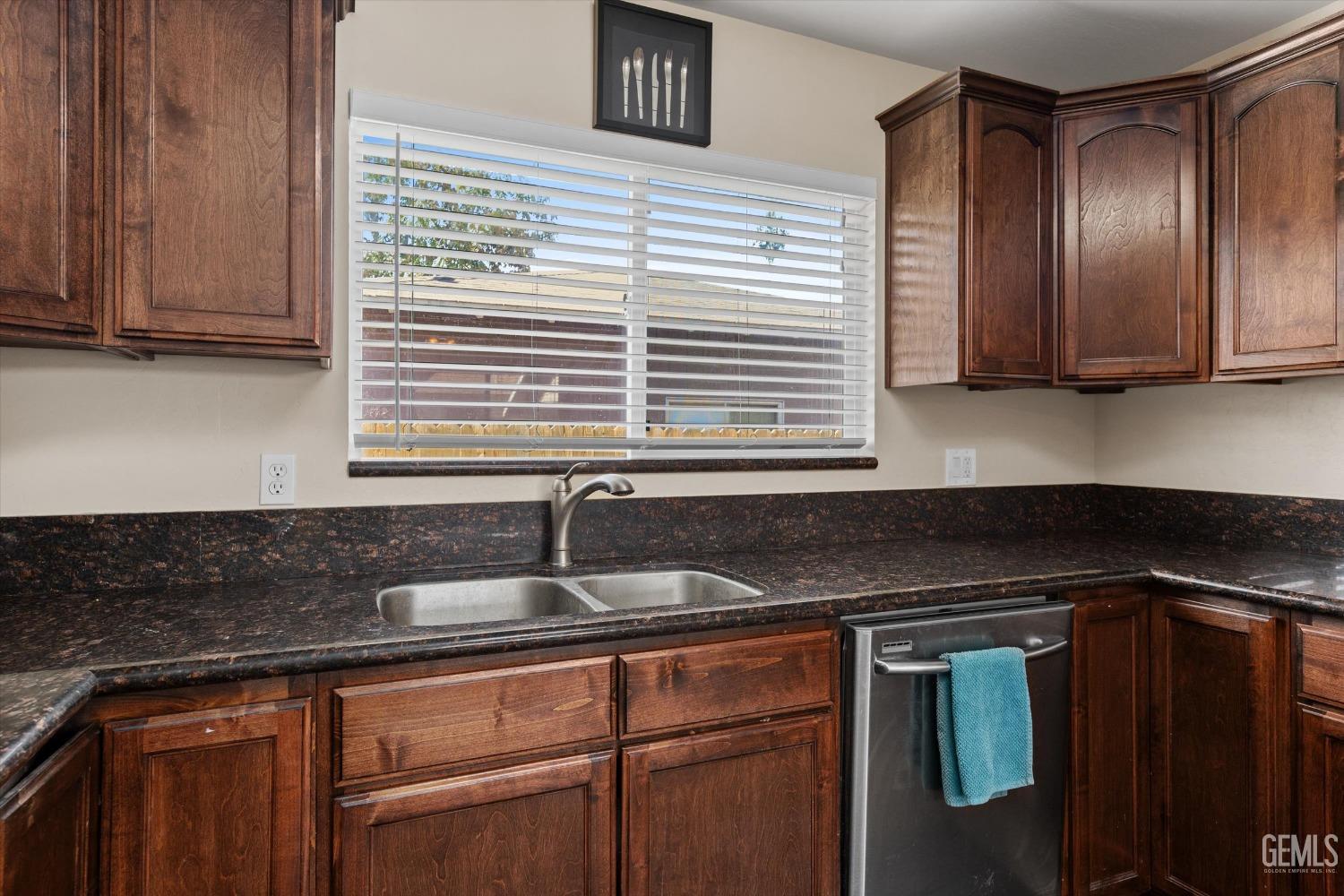 Undisclosed Address Bakersfield, CA 93309 - Photo 15 of 31 a kitchen with granite countertop cabinets and window