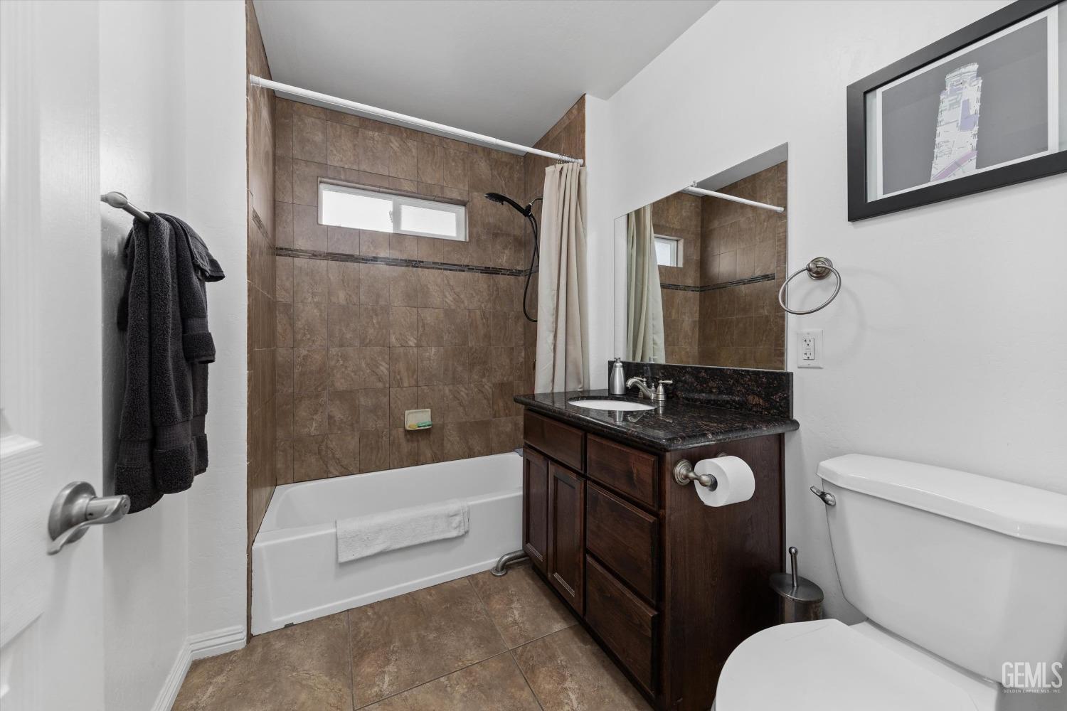 Undisclosed Address Bakersfield, CA 93309 - Photo 17 of 31 a bathroom with a toilet a sink and bathtub