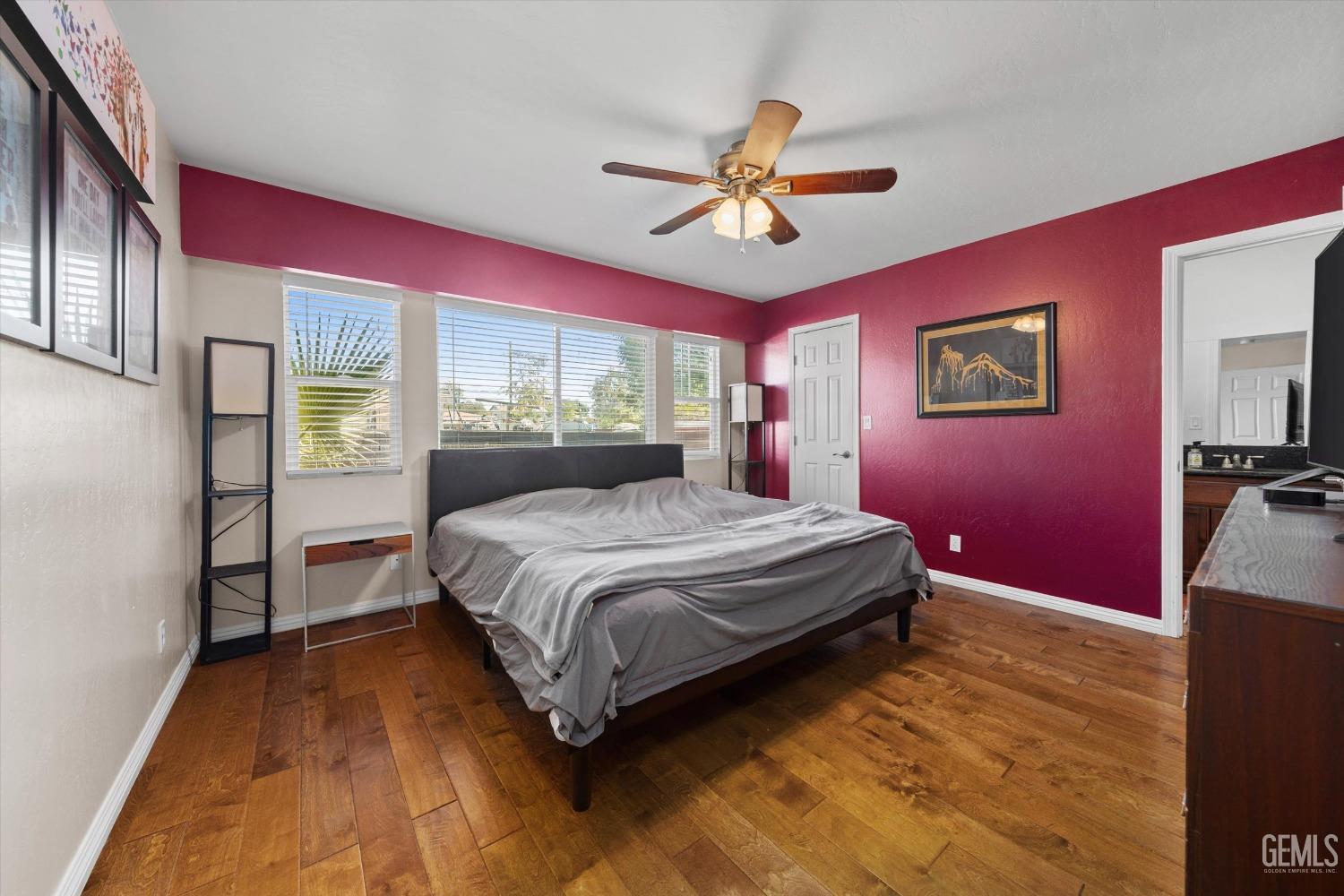 Undisclosed Address Bakersfield, CA 93309 - Photo 20 of 31 a spacious bedroom with a bed and a chandelier