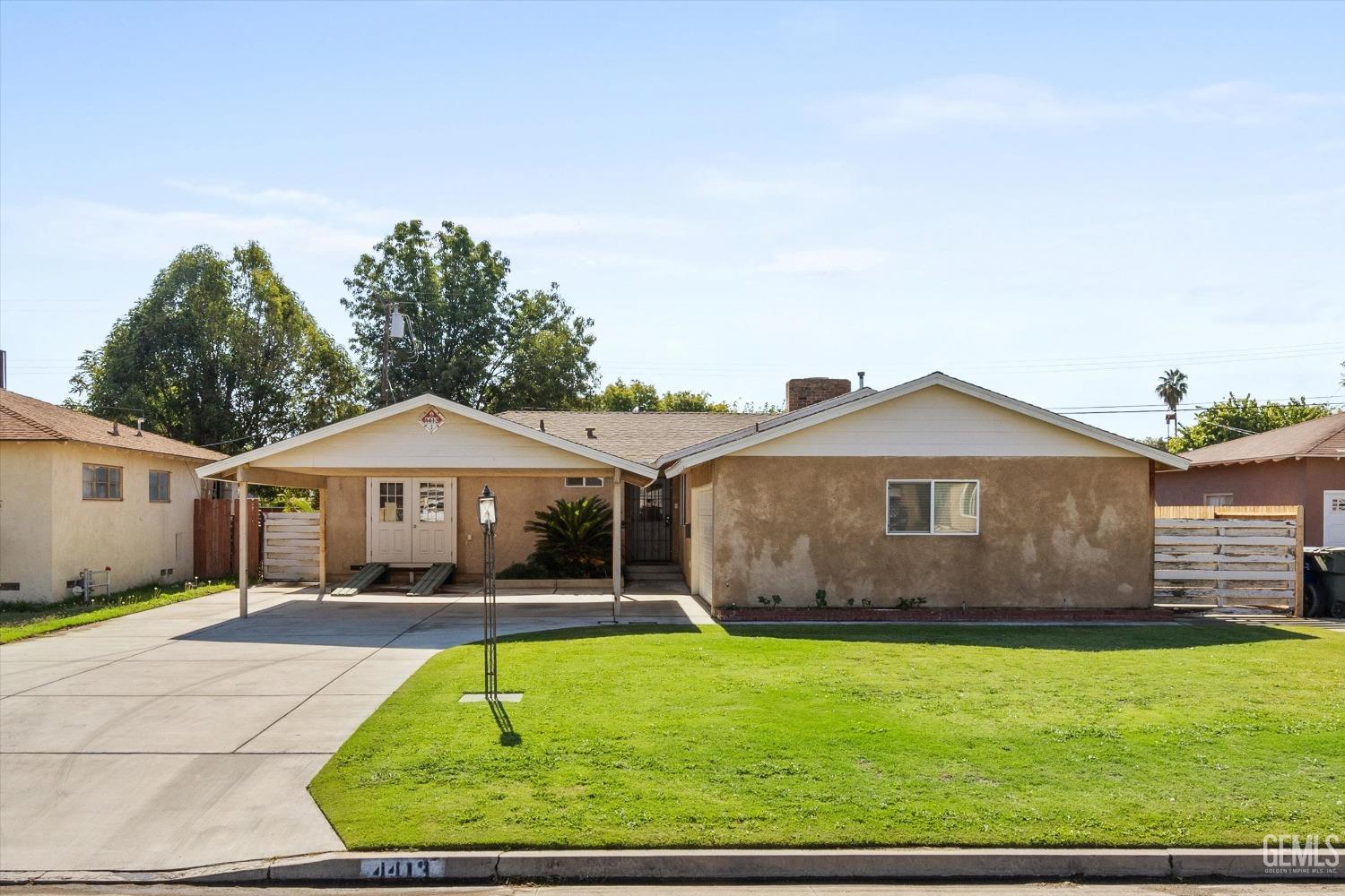 Undisclosed Address Bakersfield, CA 93309 - Photo 2 of 31 a front view of a house with a yard