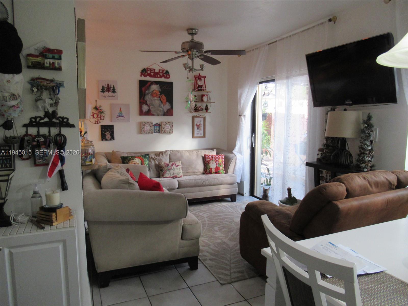 6601 Southwest 137th Court, Unit 2B Miami, FL 33183 - Photo 17 of 41 a living room with furniture and a flat screen tv