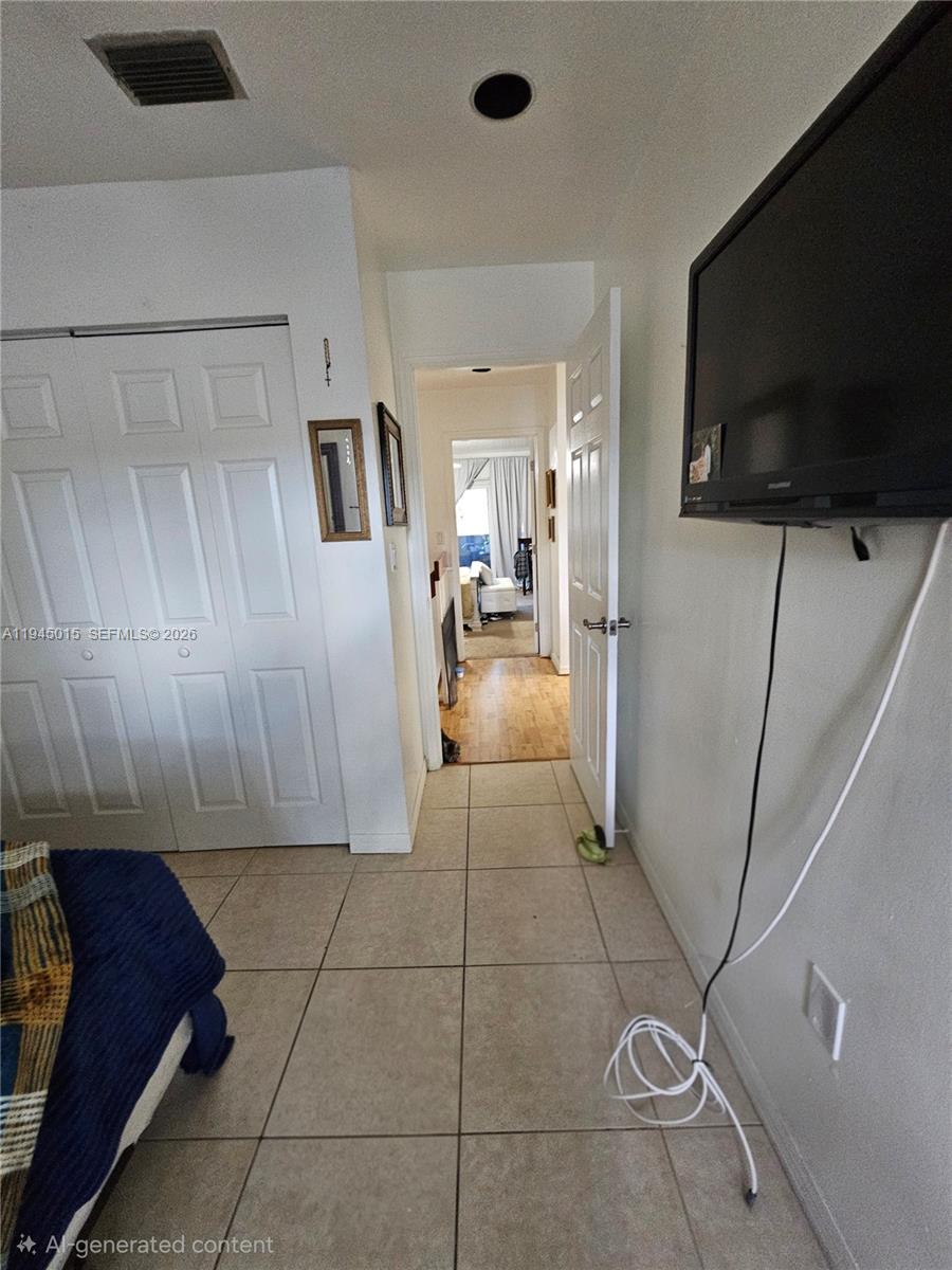 6601 Southwest 137th Court, Unit 2B Miami, FL 33183 - Photo 30 of 41 a view of a livingroom with furniture and a flat screen tv