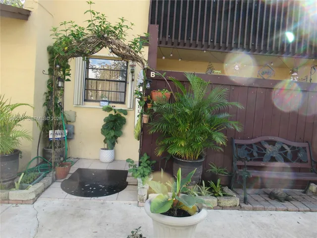 a potted plant sitting in front of a house