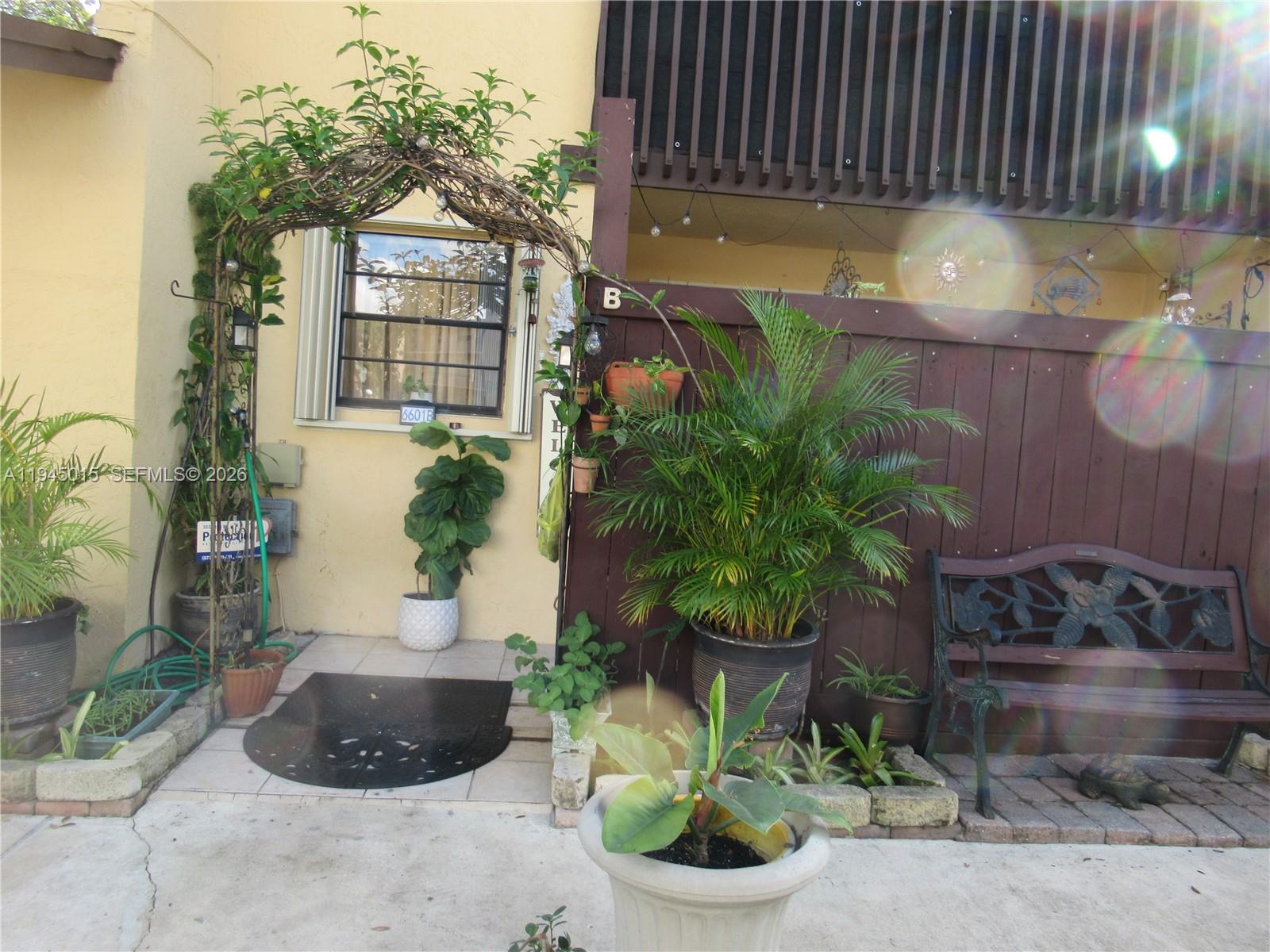 6601 Southwest 137th Court, Unit 2B Miami, FL 33183 - Photo 3 of 41 a potted plant sitting in front of a house