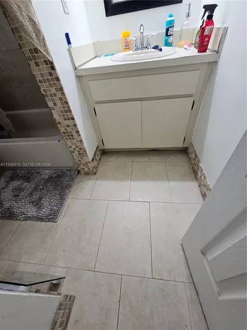 a bedroom with wooden floor and stairs
