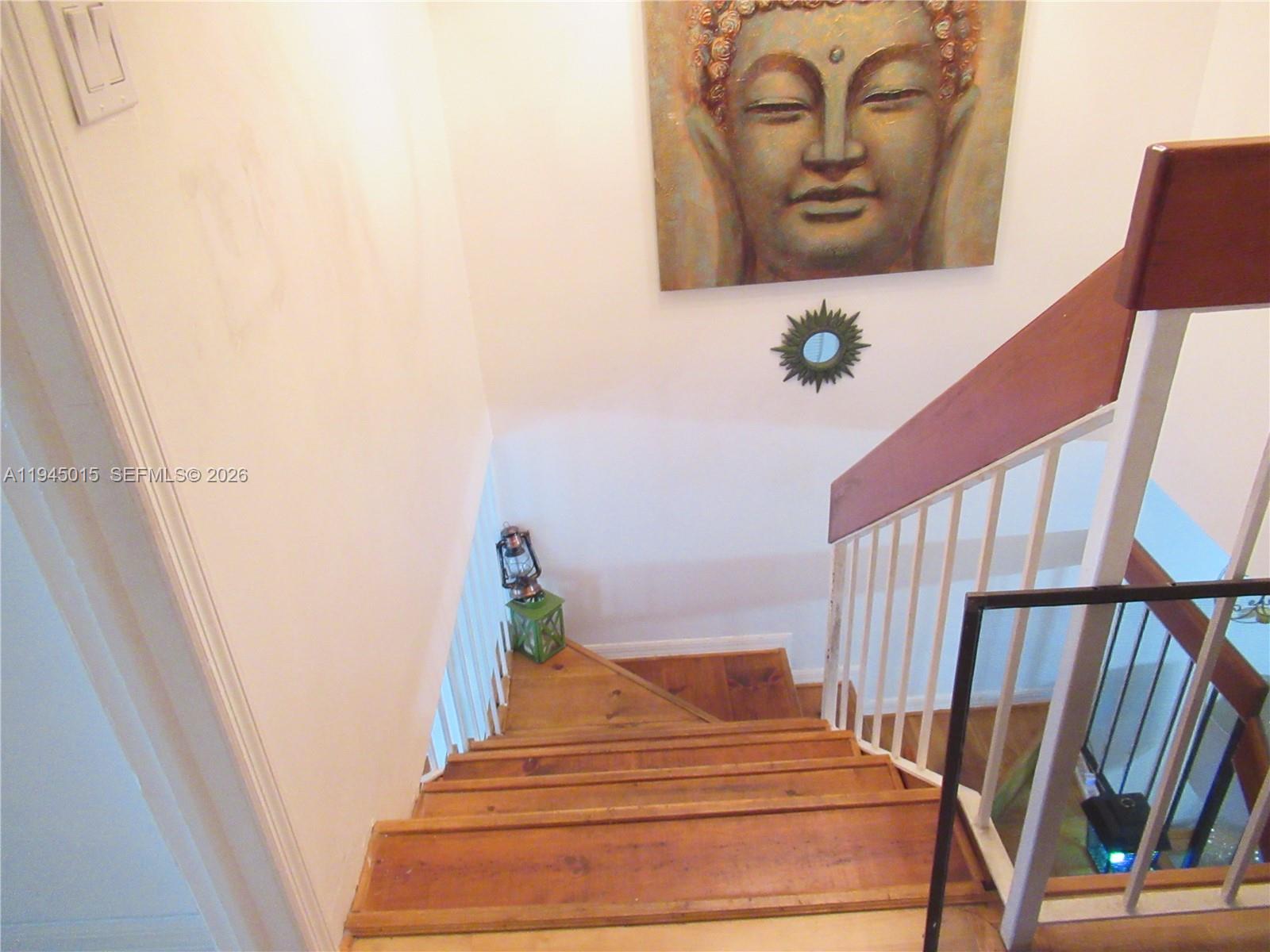 6601 Southwest 137th Court, Unit 2B Miami, FL 33183 - Photo 35 of 41 a bedroom with wooden floor and stairs