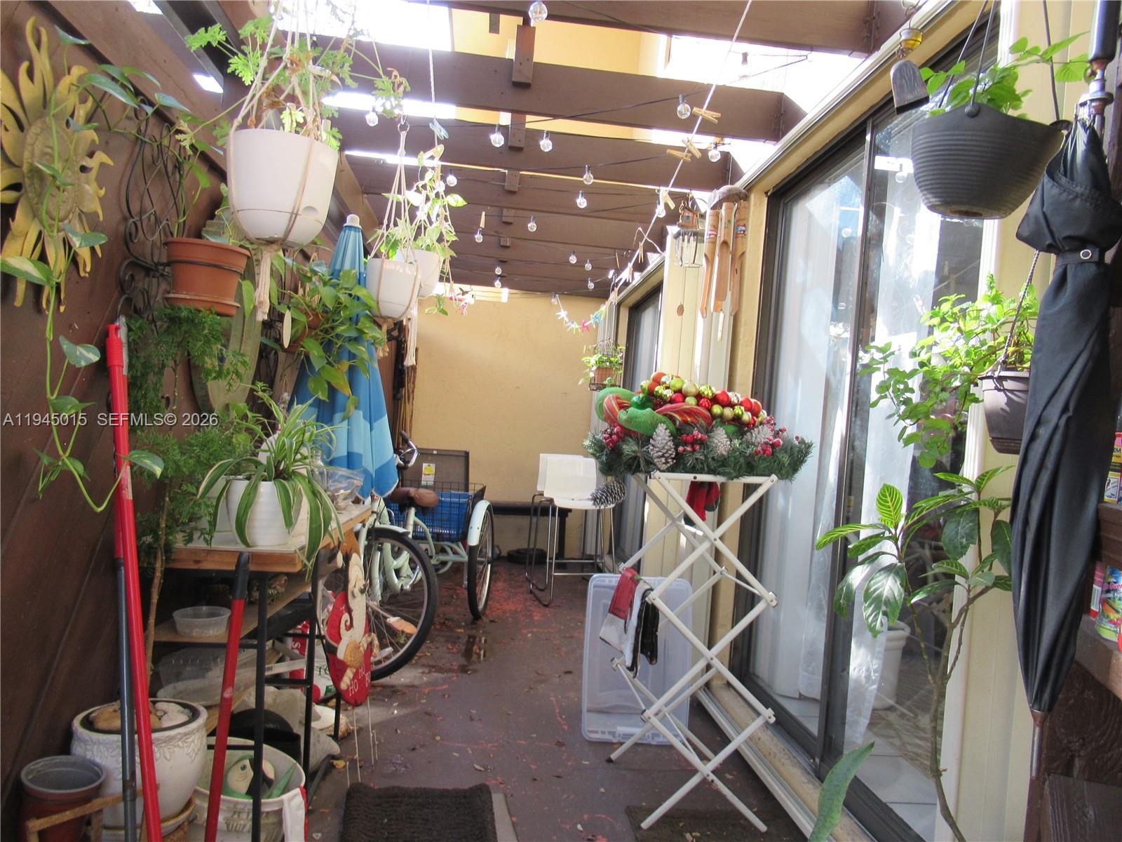 6601 Southwest 137th Court, Unit 2B Miami, FL 33183 - Photo 37 of 41 a table tennis table with chairs and a potted plant