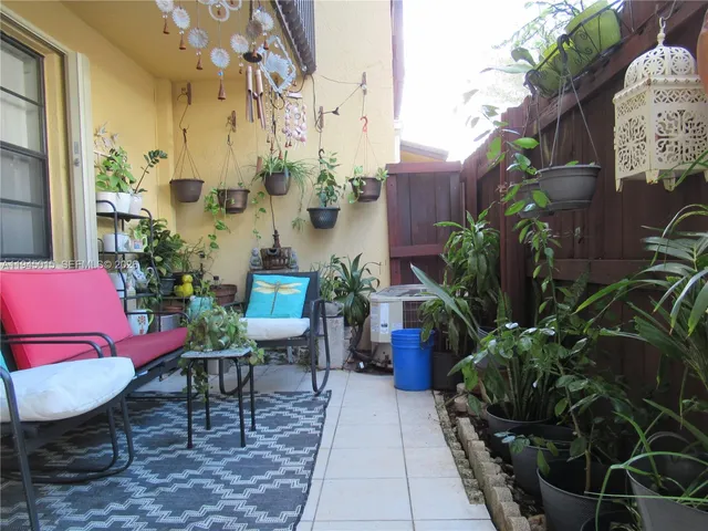 a view of a chairs and table in a patio