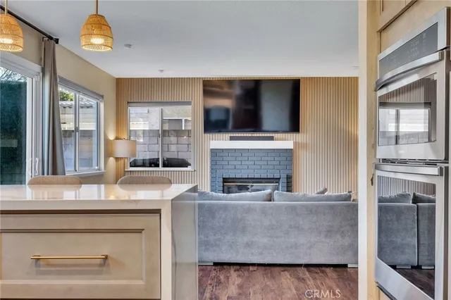 a kitchen with stainless steel appliances kitchen island granite countertop a refrigerator and a stove top oven