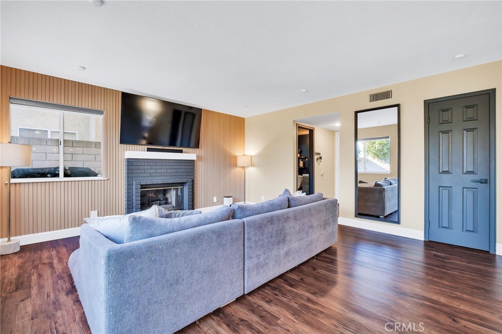 1780 North Azure Street Anaheim, CA 92807 - Photo 28 of 68 a living room with furniture a flat screen tv and a fireplace