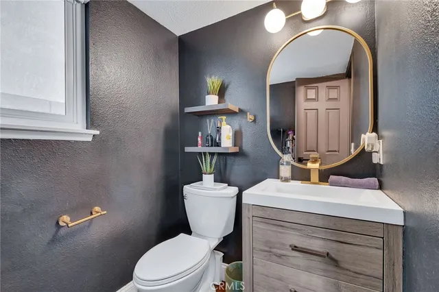 a spacious bedroom with a bed and a flat screen tv